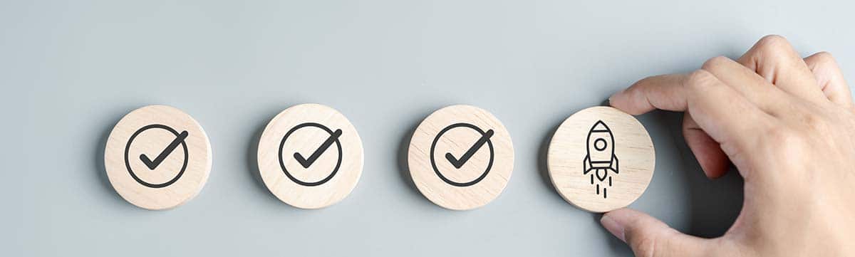 Image of three circles with check marks signifying passed tests. The last circle is a rocket signifying the website design launch